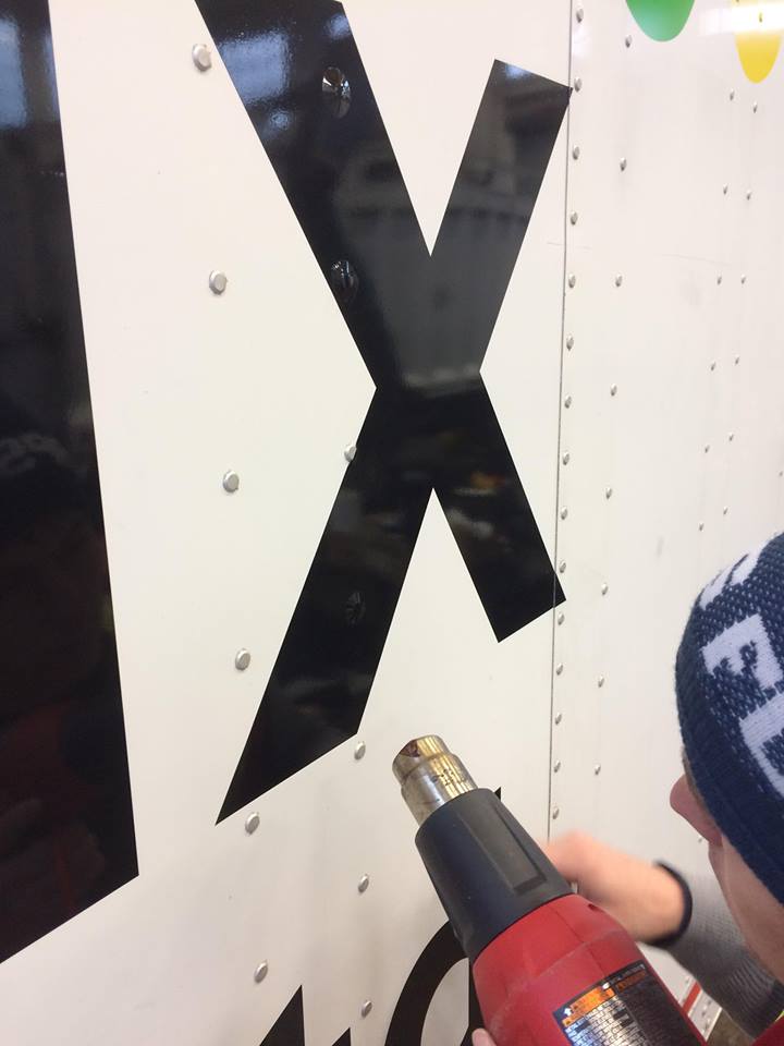 Heat guns are used to soften vinyl. This allows decals to conform around curved surfaces such as rivets.